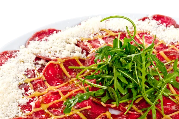 stock image Meat (beef) Carpaccio with Parmesan Cheese and ruccola