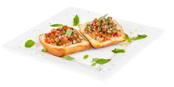 Bruschetta (italiensk rostat vitlöksbröd) med tomat — Stockfoto