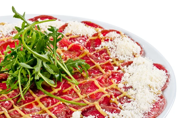 stock image Meat (beef) Carpaccio with Parmesan Cheese and ruccola