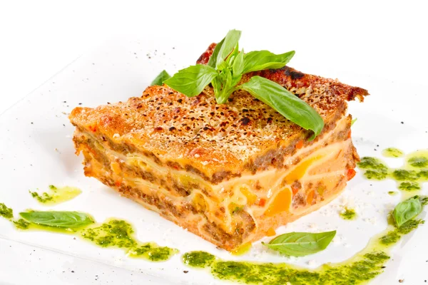 Closeup of lasagna and basil fork — Stock Photo, Image