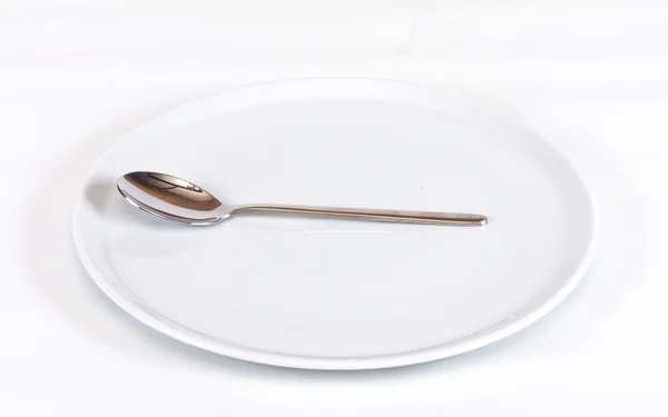 stock image Close up of spoon and plate on white background