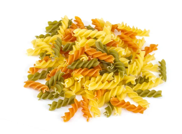 Uncooked pasta fusilli in different colours, white background — Stock Photo, Image