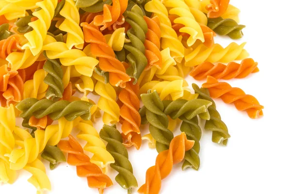 Uncooked pasta fusilli in different colours, white background — Stock Photo, Image