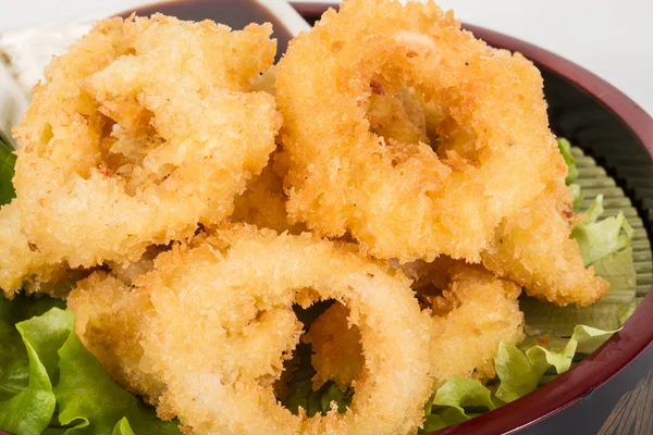 stock image Deep batter fried squid rings calamari with green salad