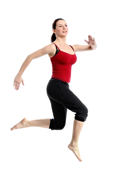 Menina em sportswear salto saltando sobre branco — Fotografia de Stock