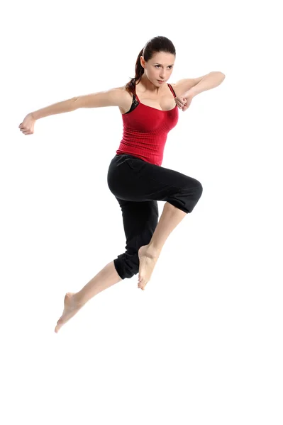 Chica en ropa deportiva saltando saltando sobre blanco Imagen De Stock
