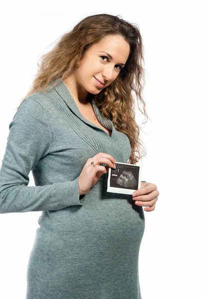 Pregnant woman holding ultrasound picture — Stock Photo, Image