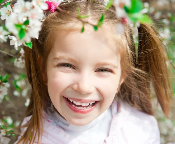 Little girl with bush blossoming — Stock Photo, Image