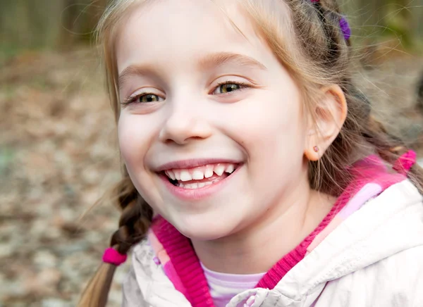 Little girl with bush blossoming — Stock Photo, Image