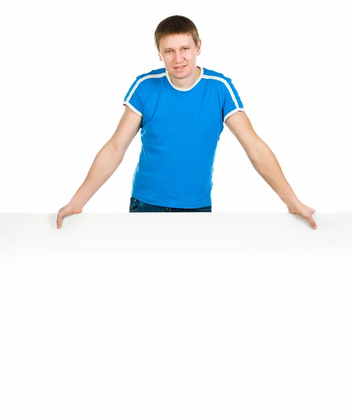 Man standing behind blank billboard — Stock Photo, Image