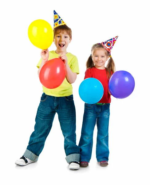 Děti v narozeniny caps — Stock fotografie