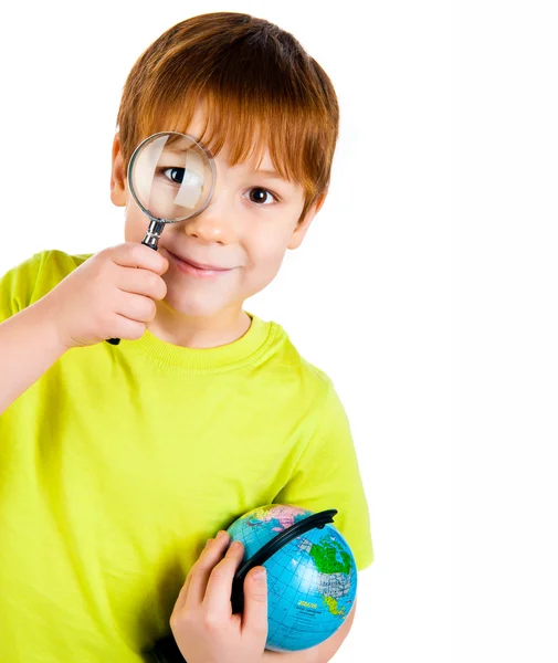 stock image Boy looking through a magnifying glass
