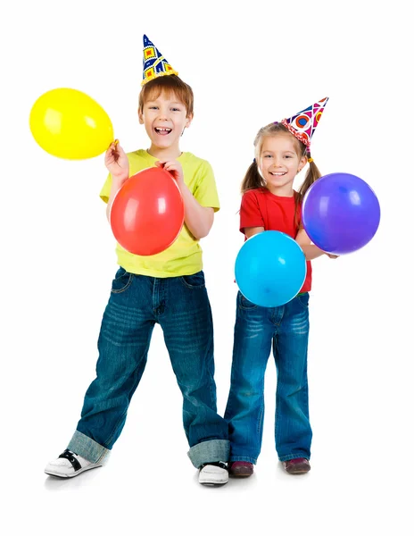 Děti v narozeniny caps — Stock fotografie