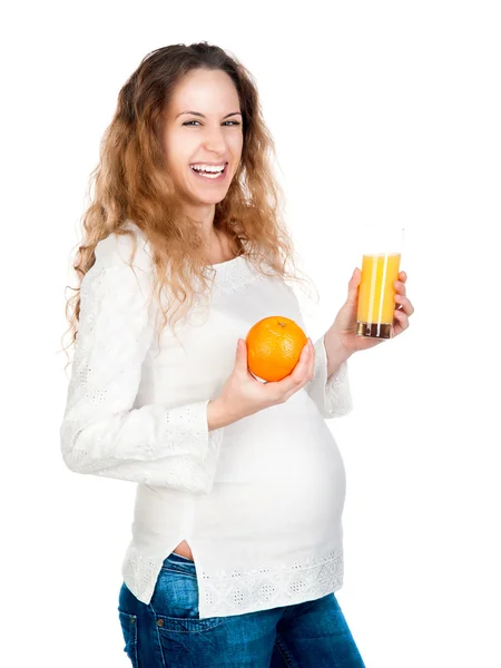 Беременная женщина с красивым желудком держит оранжевый — стоковое фото