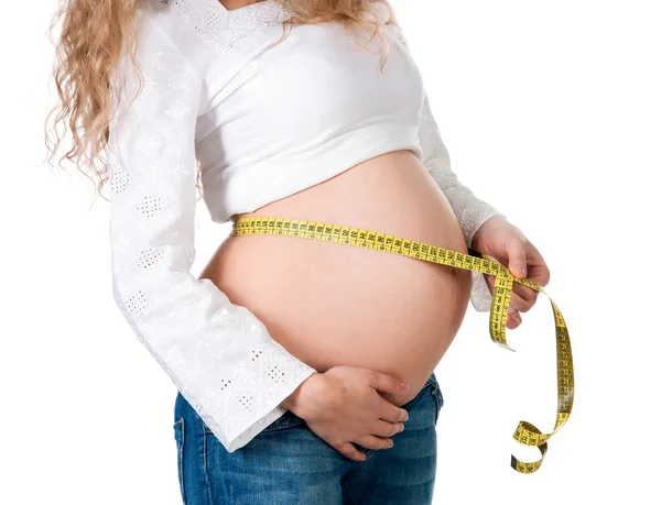 Pregnant woman measures her stomach — Stock Photo, Image