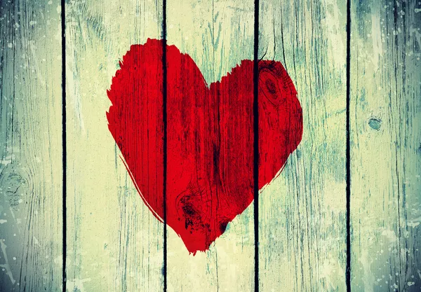 Love symbol on old wooden wall — Stock Photo, Image