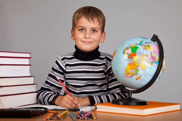 stock image Cute schoolboy is writting