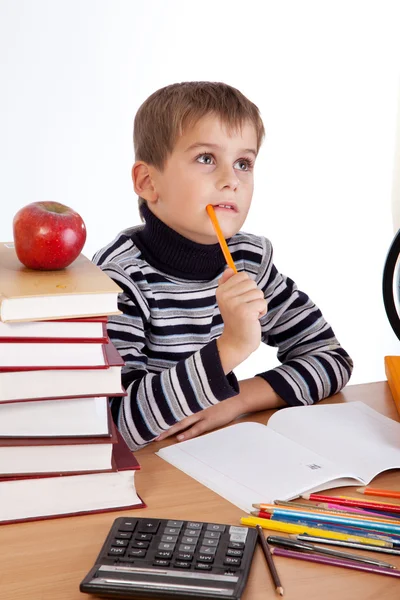 Cute schoolboy is thinking — Stock Photo, Image