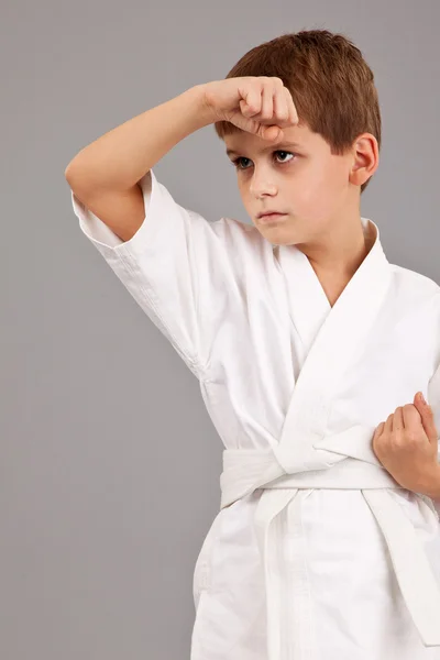 Karate boy in white kimono fighting — Stock Photo, Image