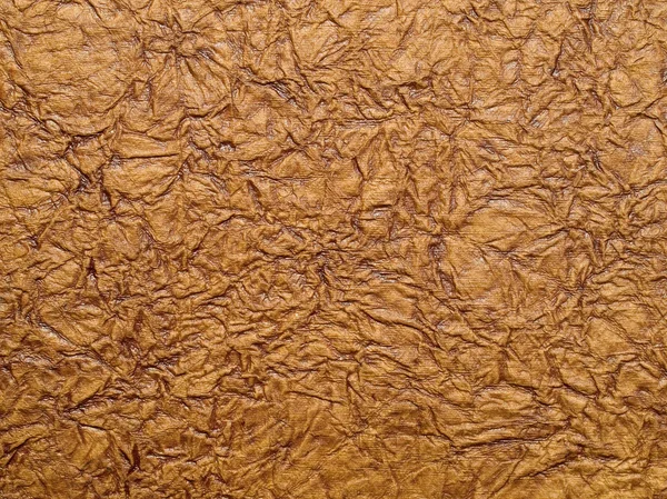 Skrynkliga brunt papper närbild textur bakgrund. — Stockfoto