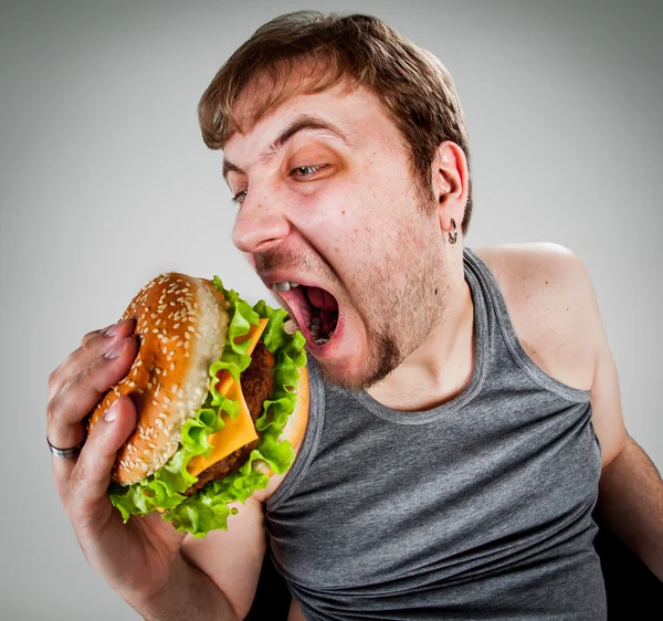 Homem gordo comer hambúrguer Imagem De Stock