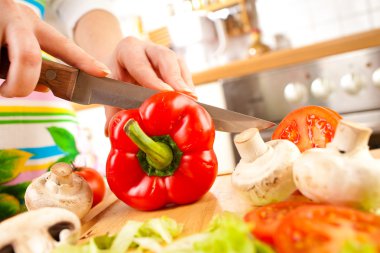 Woman's hands cutting vegetables clipart