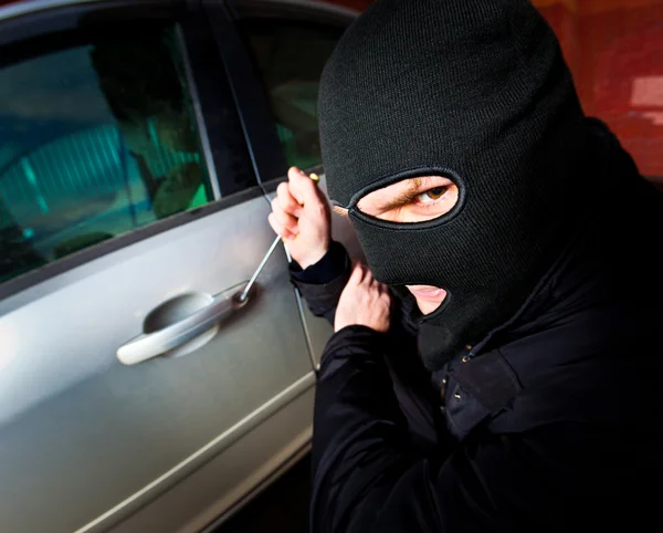 Robber and the thief in a mask hijacks the car Royalty Free Stock Photos