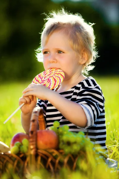 Little boy with a sweet — Stock Photo, Image