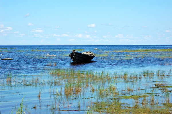 Wooden boat near the lake bank