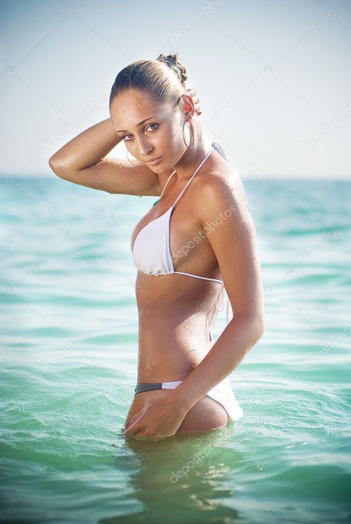 Portrait of a beautiful young woman in the sea