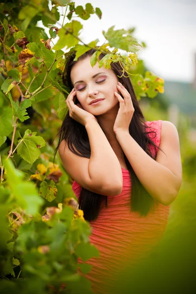 Portrait of young beautiful woman in grapes — Stock Photo, Image
