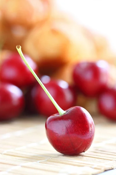 stock image Fresh red cherry on wooden table