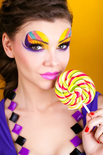 Portrait of a glamourous beautiful woman holding lollipop — Stock Photo, Image