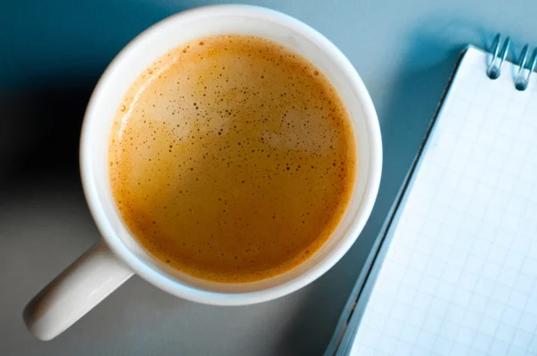 Cup of coffee and notebook — Stock Photo, Image