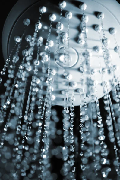 stock image Closeup view of water flowing out of shower in dark