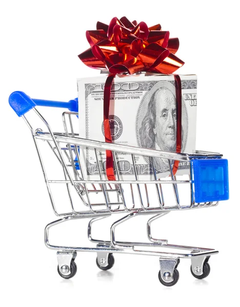 Gift box made of dollars in shopping cart — Stock Photo, Image