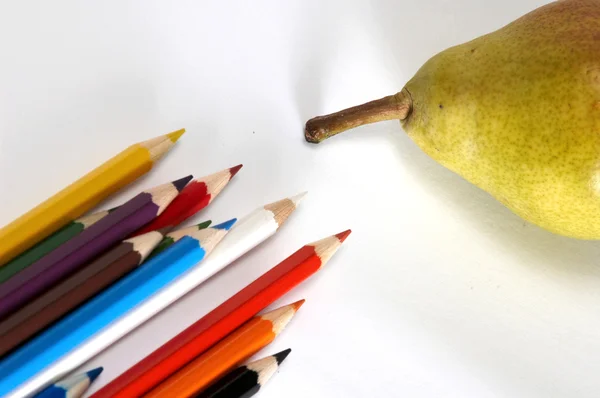 Pencils and yellow pear — Stock Photo, Image