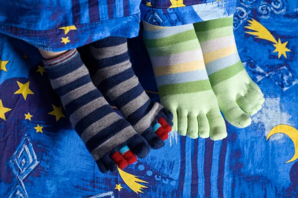 Two pairs of feet in socks — Stock Photo, Image