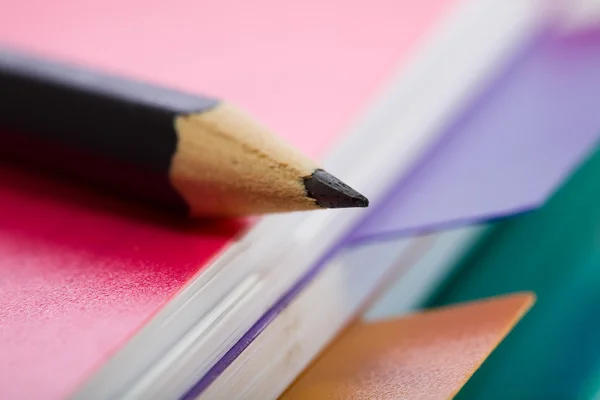 Różowy notatnik i ołówek czarny — Zdjęcie stockowe