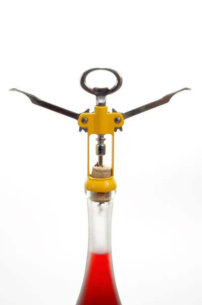 Yellow corkscrew and wine — Stock Photo, Image