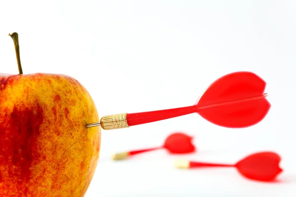 Red apple with darts — Stock Photo, Image