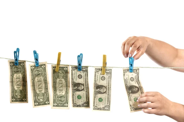 Hands and dollars on clothesline — Stock Photo, Image