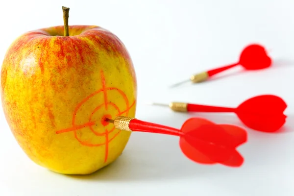 Yellow apple with darts — Stock Photo, Image