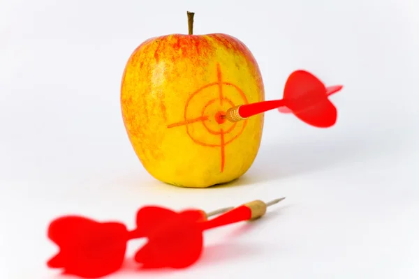 Red-yellow apple with dart — Stock Photo, Image