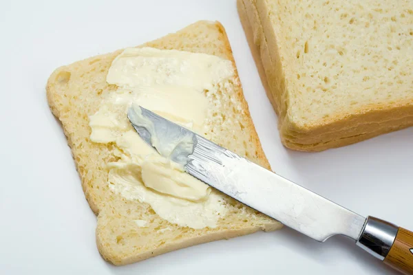 Skivor bröd med smör — Stockfoto