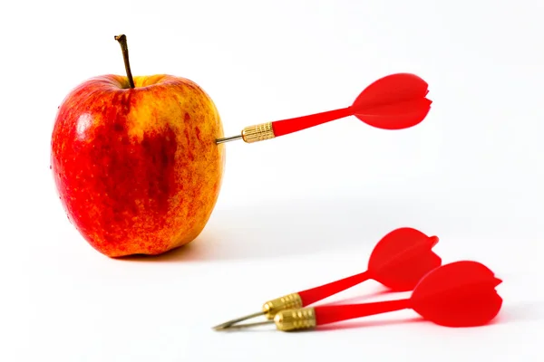 Apple with red darts — Stock Photo, Image