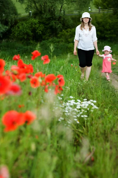 Ma and daughter among field — стоковое фото