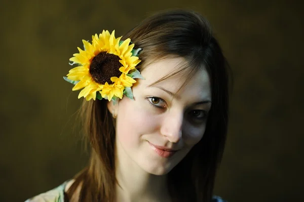 Yellow sunflower in hair — Stock Photo, Image