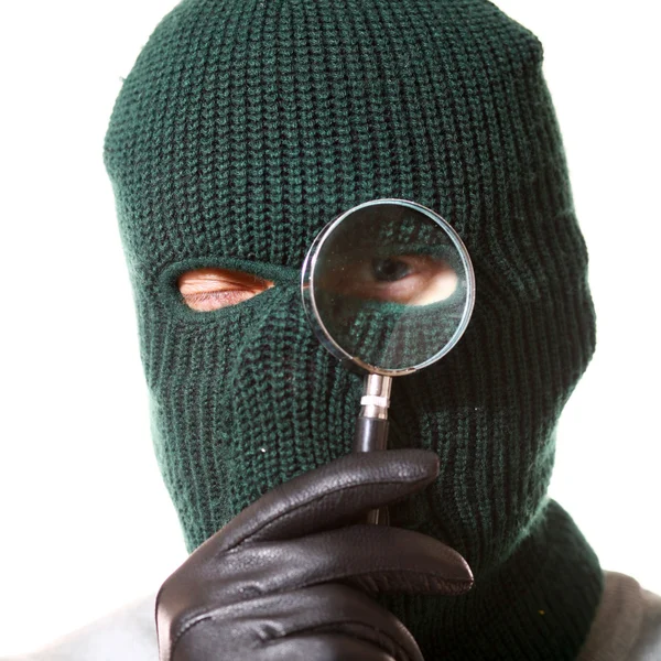 Thief with magnifier — Stock Photo, Image