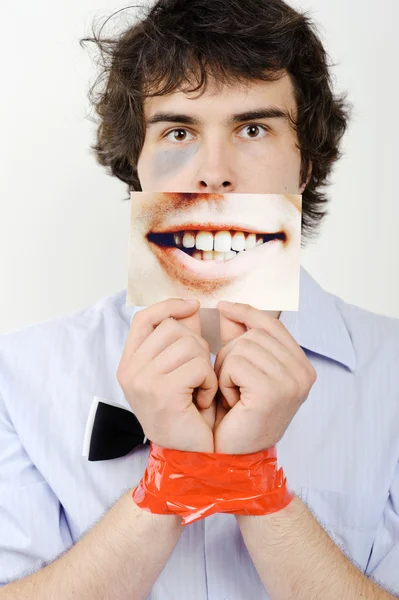 Tape on hands and a photo of a smile — Stock Photo, Image